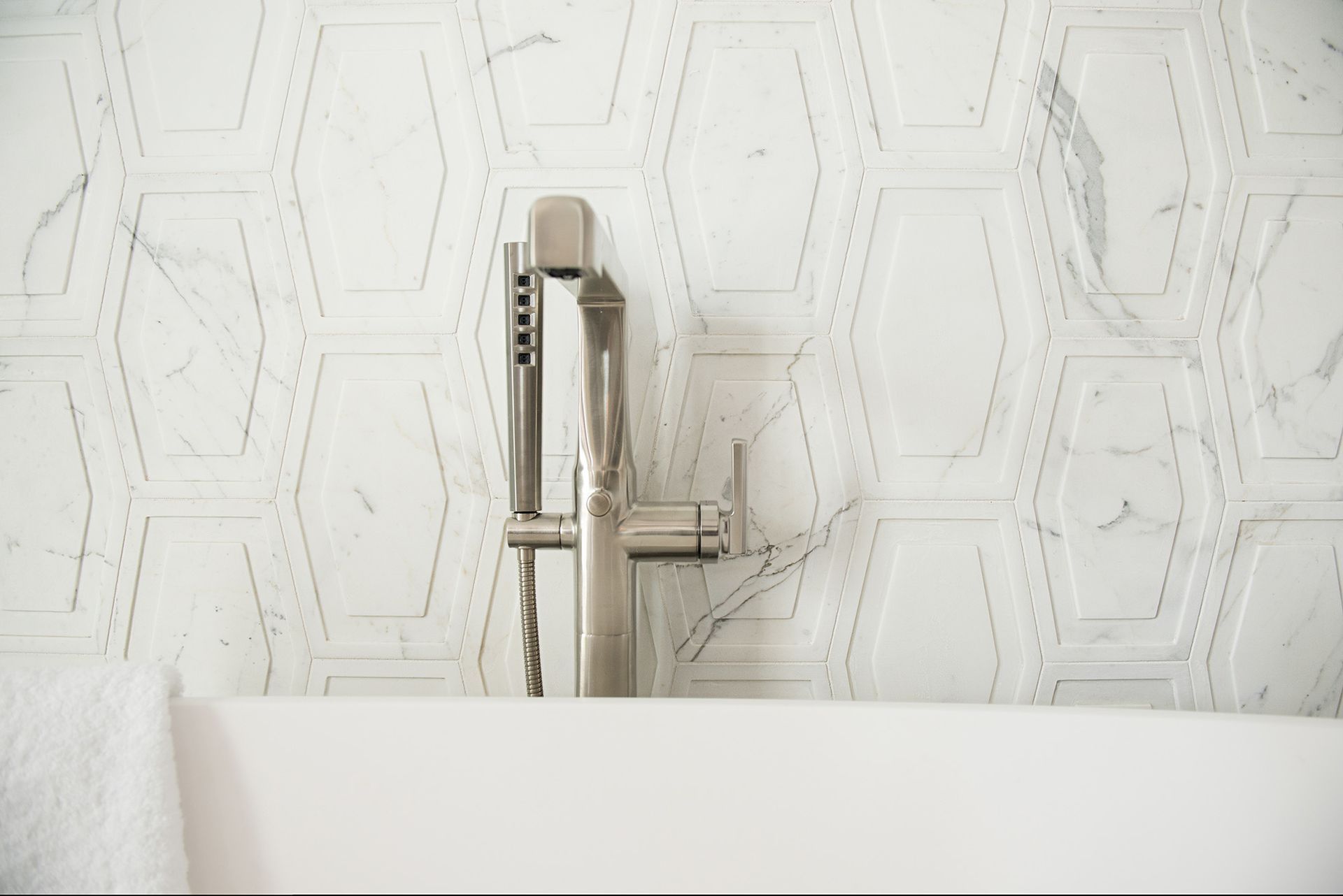 A bathroom with a bathtub and a faucet on the wall