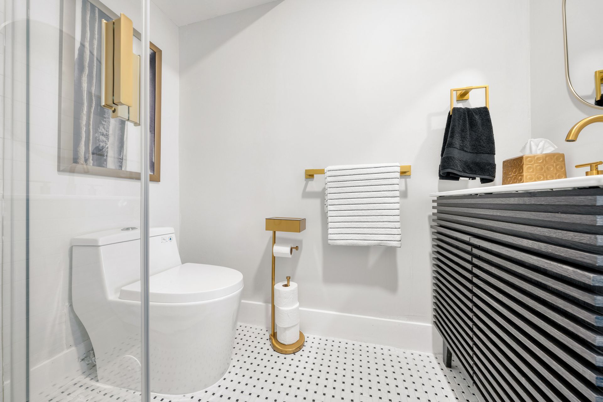 A bathroom with a toilet , sink , and shower.