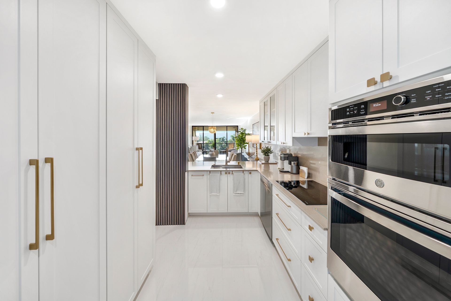 A kitchen with white cabinets and stainless steel appliances.