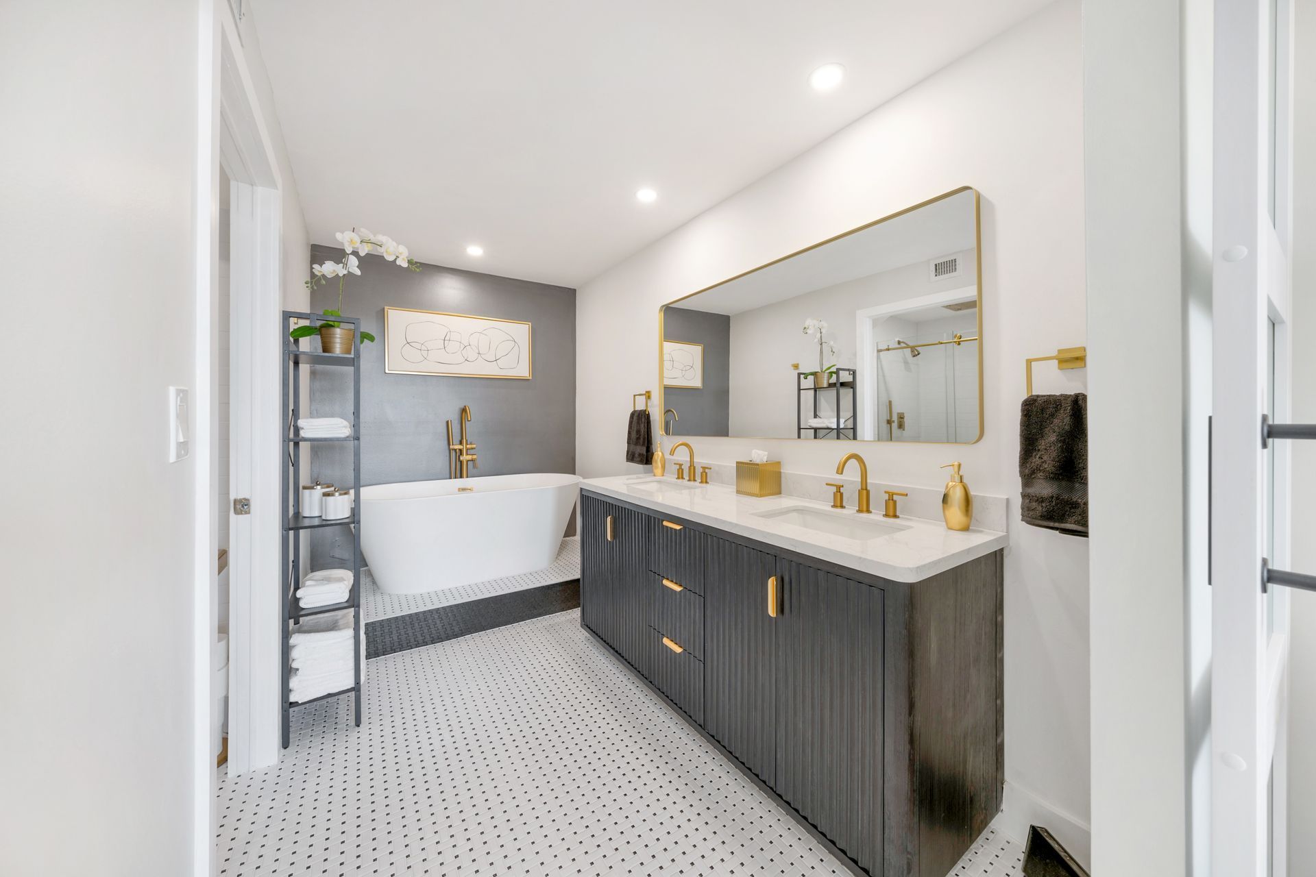 A bathroom with a bathtub , sink and mirror.