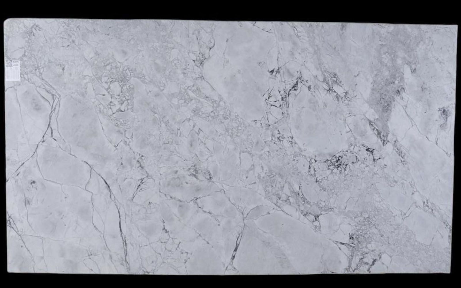 A piece of Super White Calacatta Leathered Dolomite