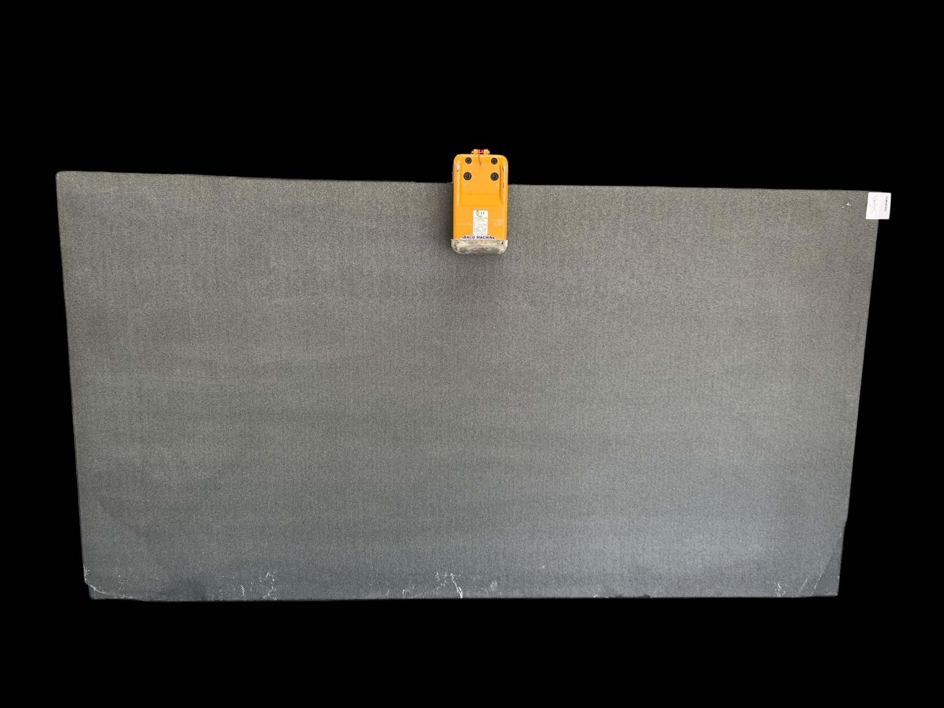 A large piece of granite is sitting on top of a black table.