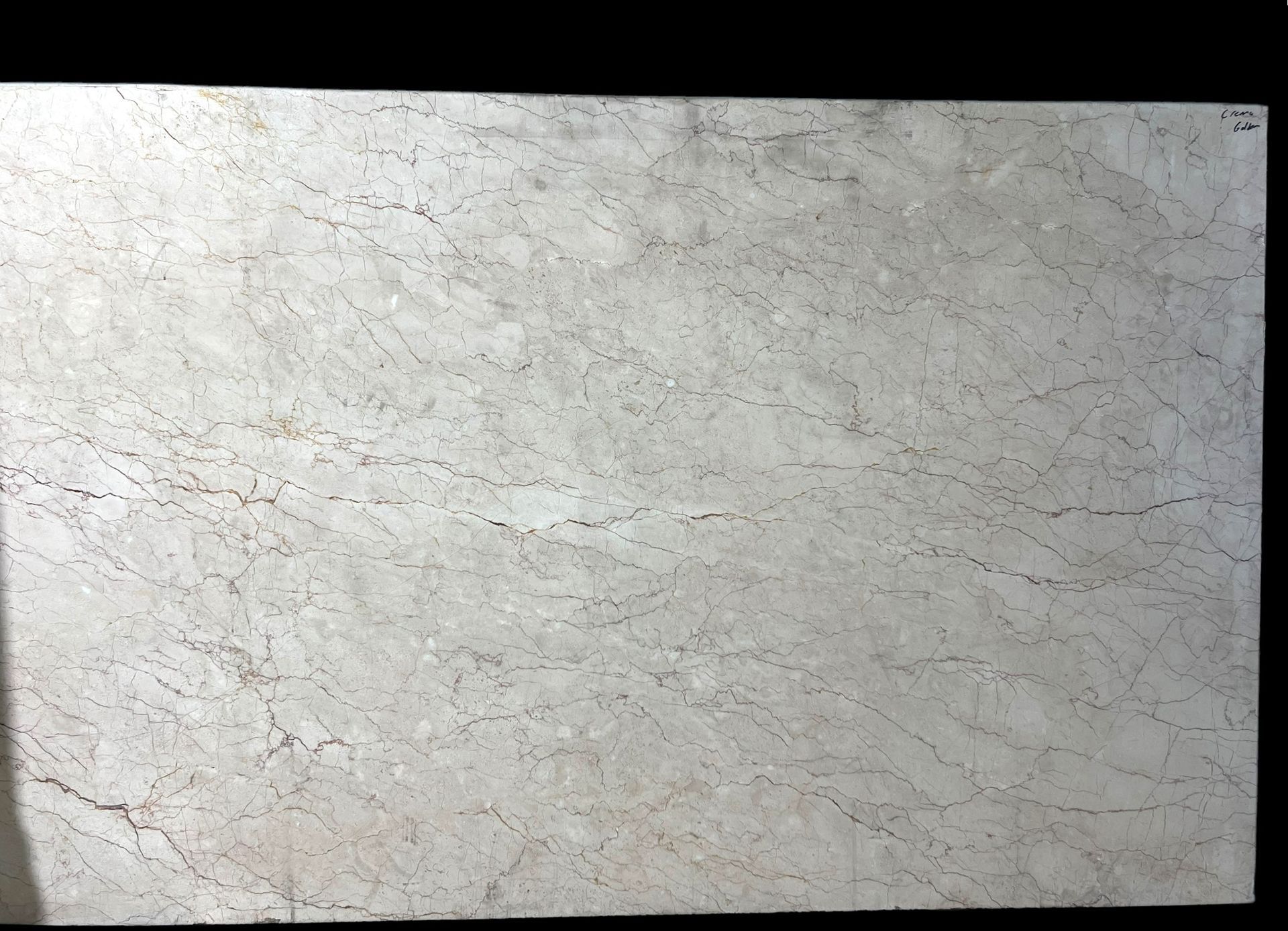 A close up of a white tile with a black background.