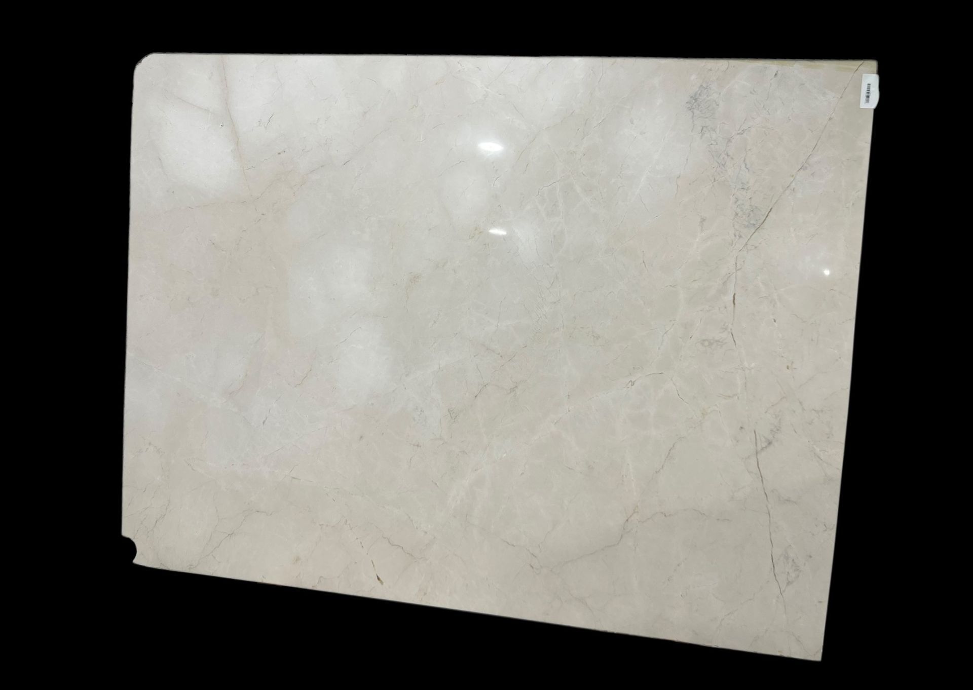 A white marble slab is sitting on a black surface.