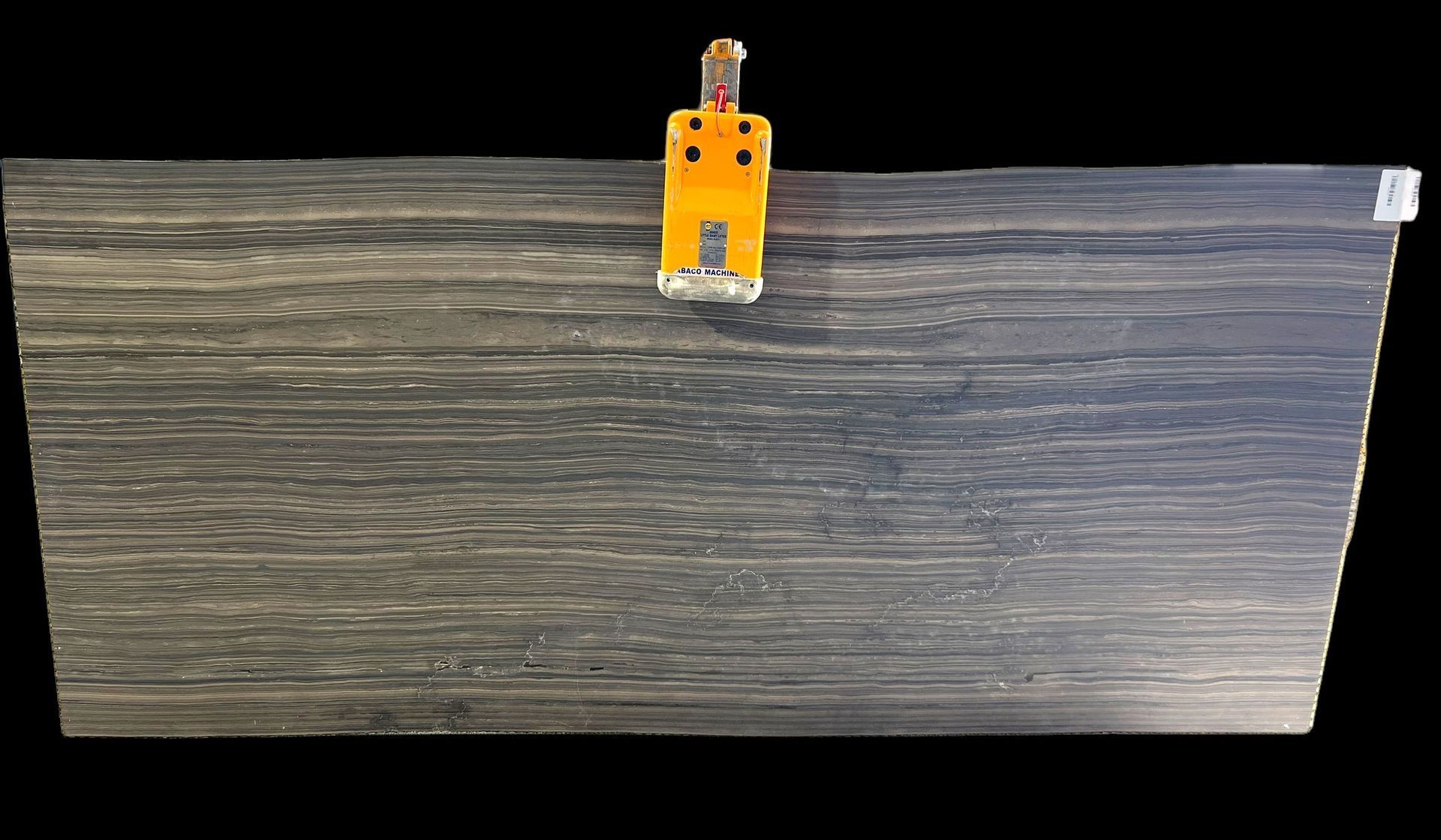 A large piece of wood with a yellow clamp attached to it.
