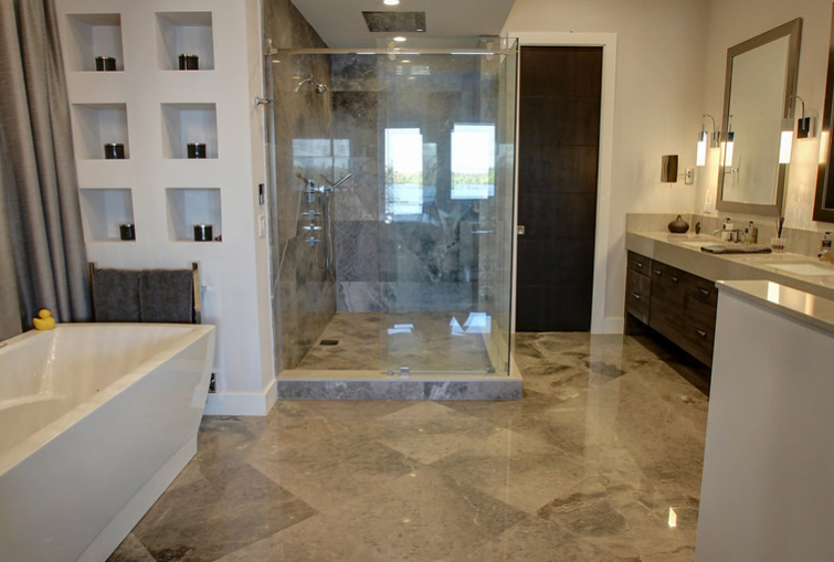 A bathroom with a walk in shower , tub , sinks and mirrors.