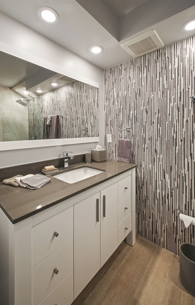 A bathroom with a sink and a large mirror