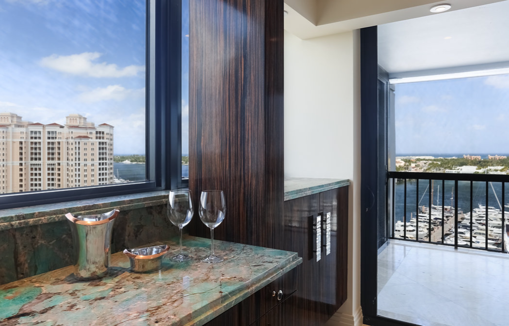 A bar with a view of a city from a balcony.