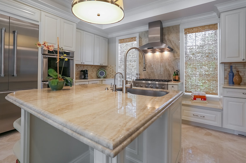 A kitchen with a large island and a sink.