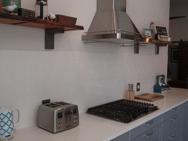 A kitchen with a stove top oven and a toaster