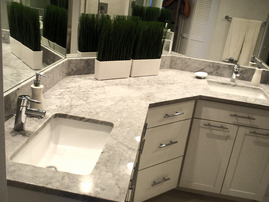 A bathroom with a sink and a large mirror