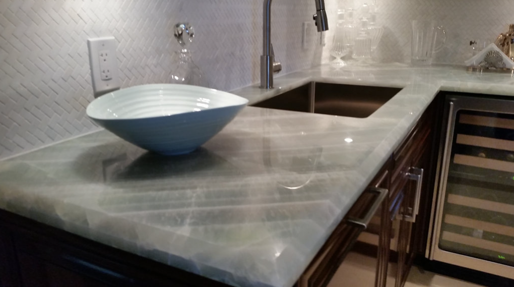 A kitchen counter with a sink and a bowl on it
