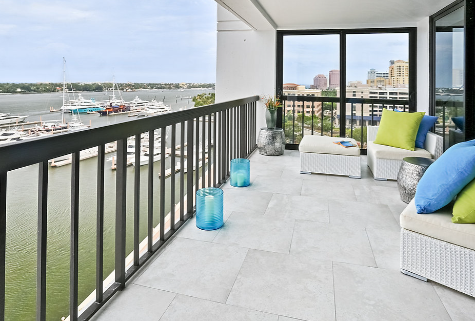 A balcony with a view of the water and boats