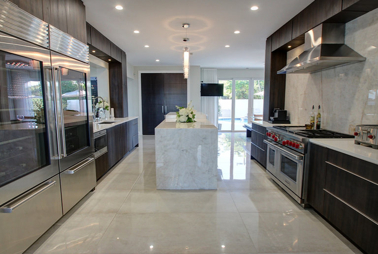 A kitchen with stainless steel appliances and a large island