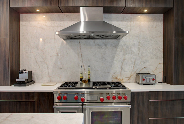 A kitchen with a stove , oven , and toaster oven.