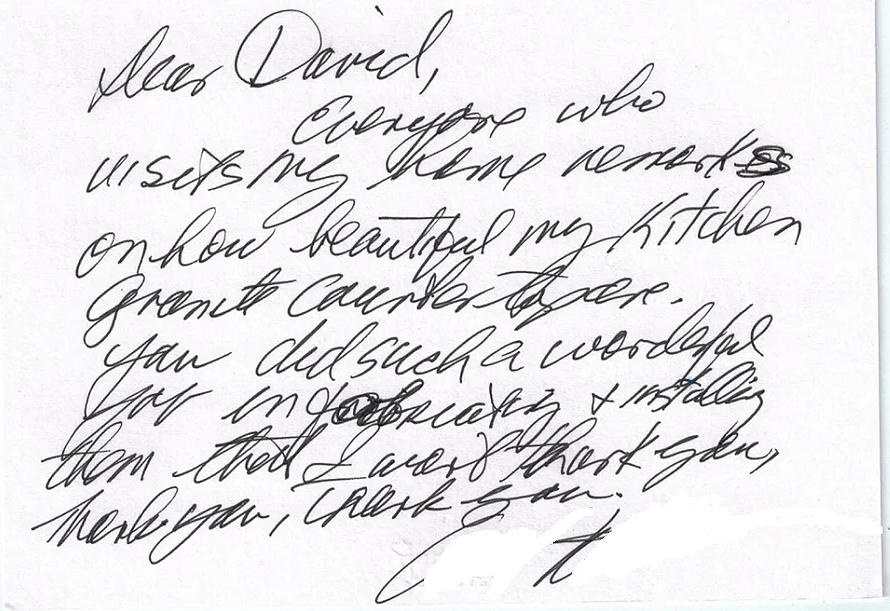 A letter is written in cursive on a piece of paper