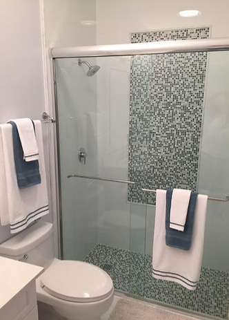 A bathroom with a toilet , sink , and shower.