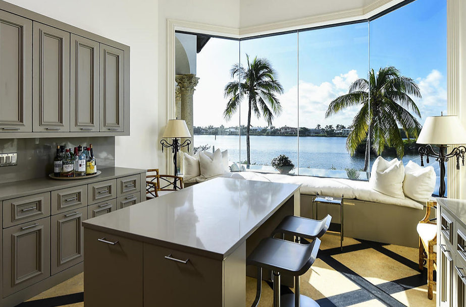A kitchen with a large island and a view of the ocean