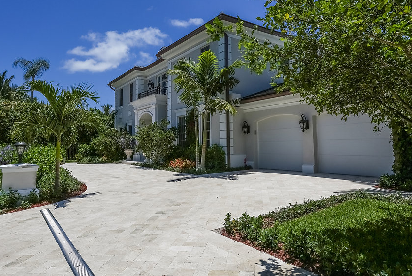 A large white house with a driveway leading to it