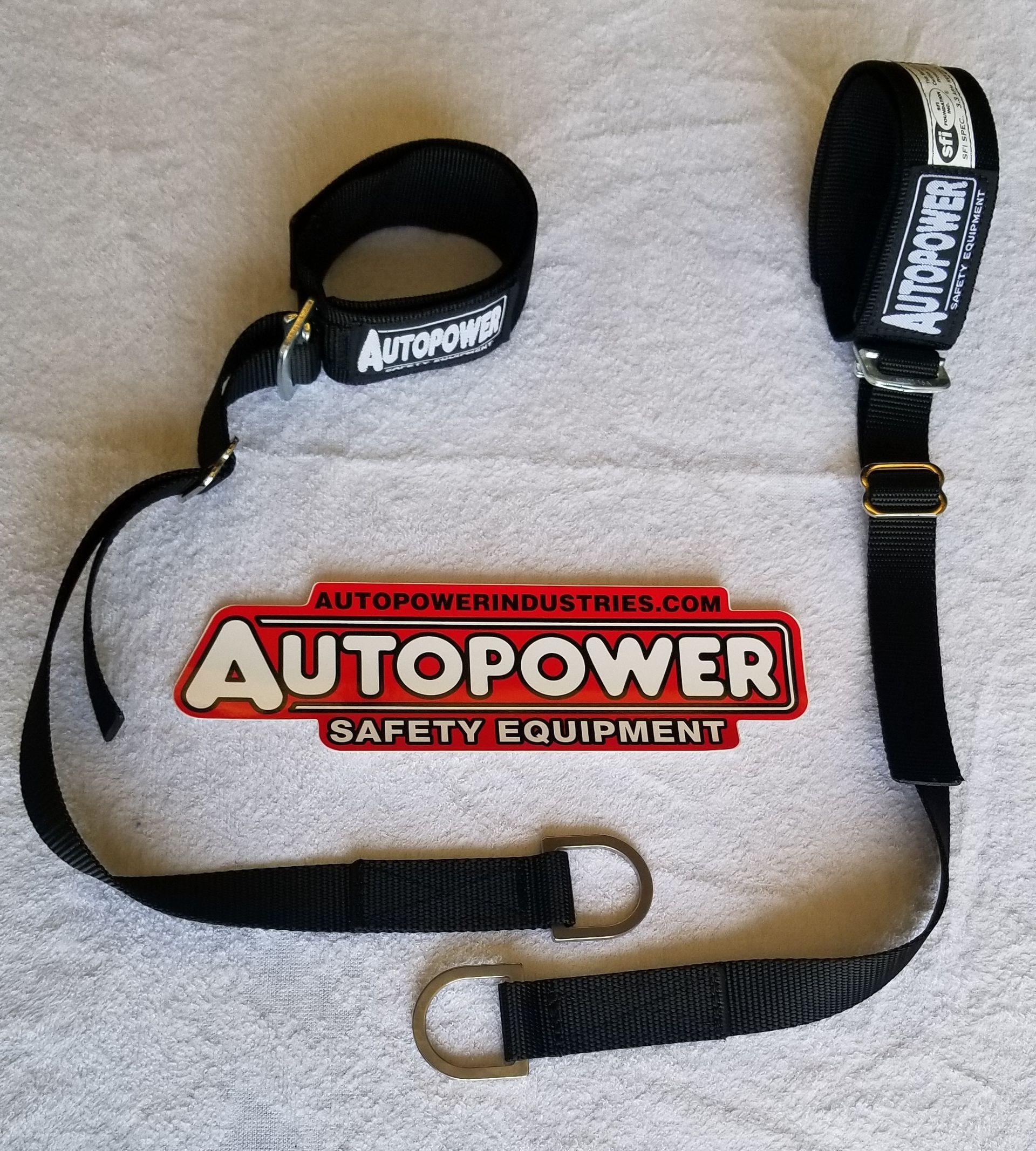 Black Auto Power safety harness with two metal rings, and red and white company logo.