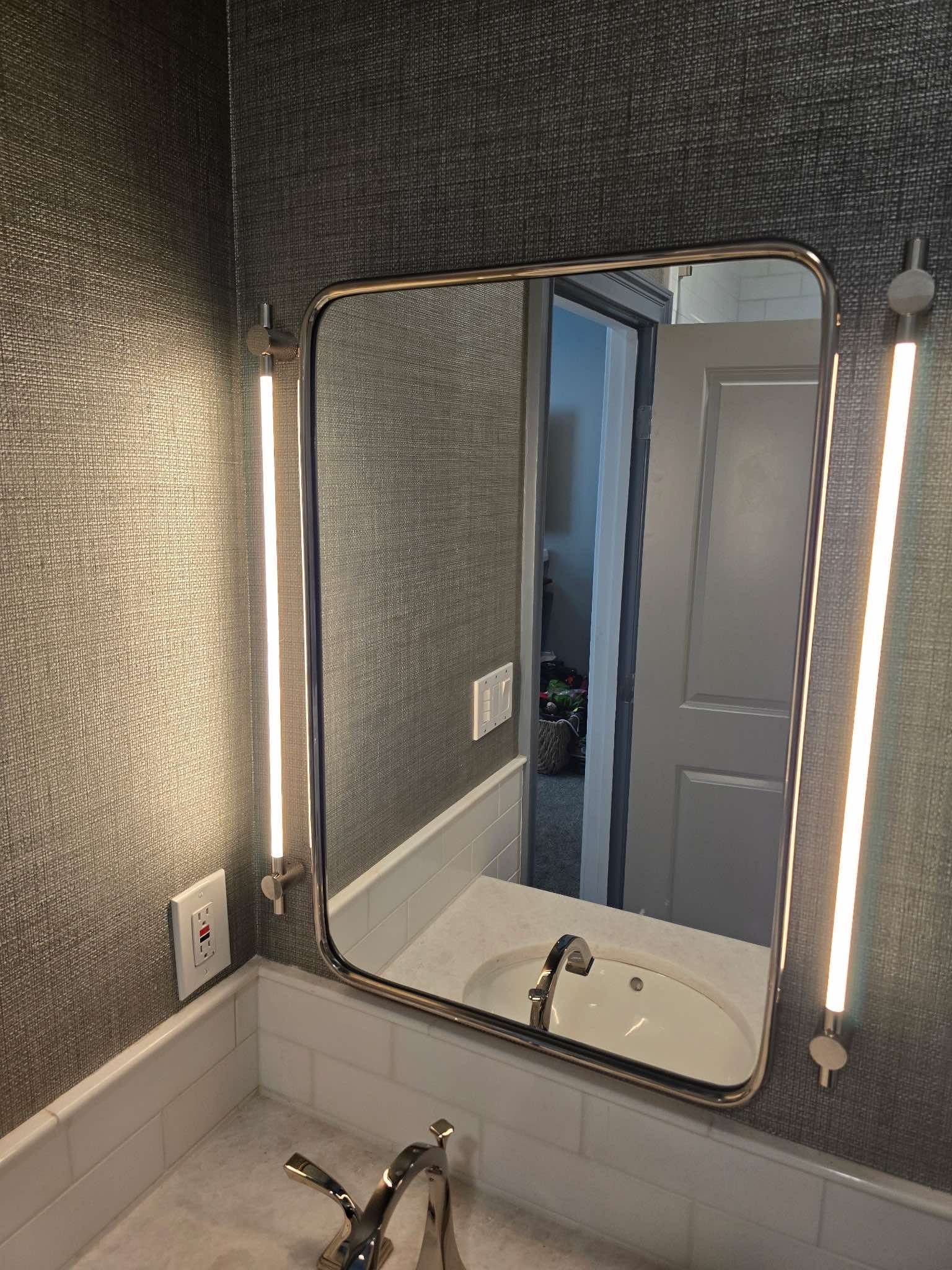 A person is pressing a button on a thermostat.