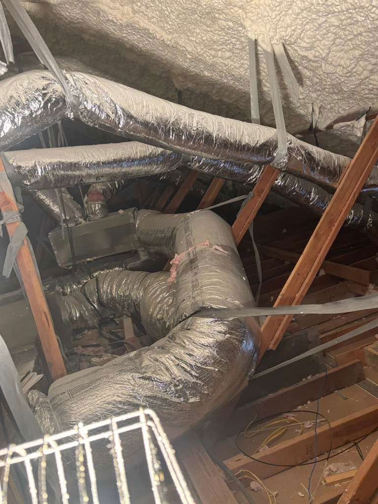 Insulated HVAC ducts and exposed ceiling beams in an attic or crawlspace