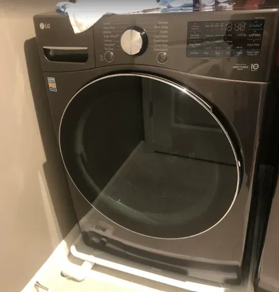 LG dark gray clothes dryer with a large glass door.