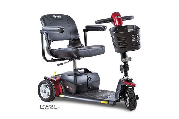 A red and black Pride Go-Go three-wheel mobility scooter with a front storage basket and black seat.