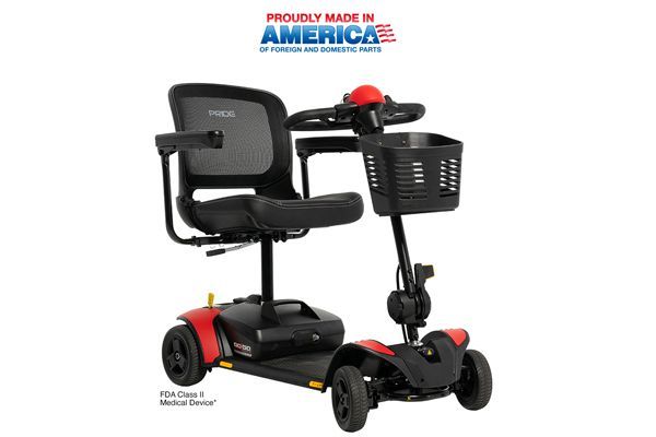 A red and black four-wheeled mobility scooter with a mesh back seat and a front storage basket.