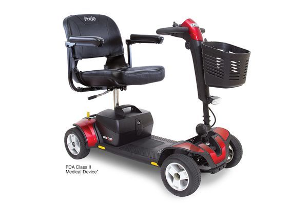 Red four-wheeled mobility scooter with a black seat and storage basket, labeled as an FDA Class II Medical Device.