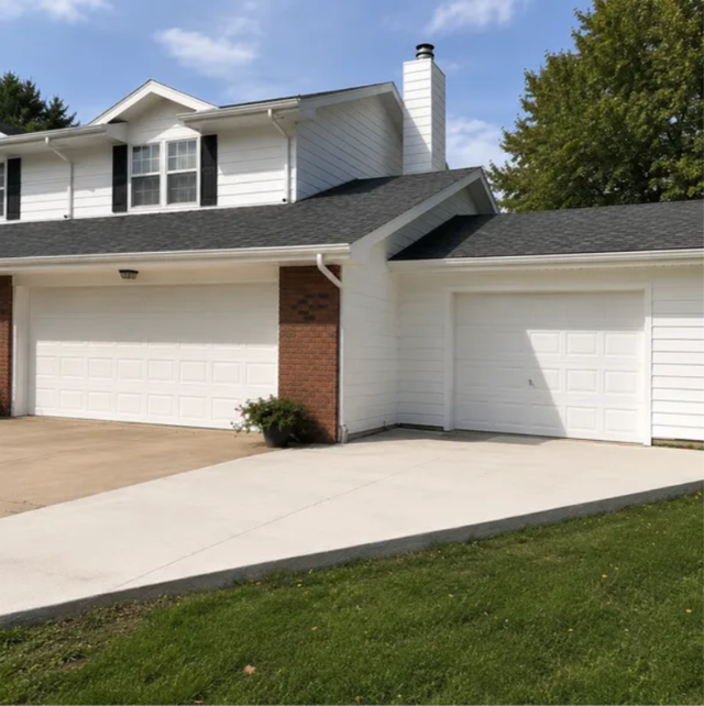 Suburban two-story house with white siding, brick accents, and a three-car garage driveway