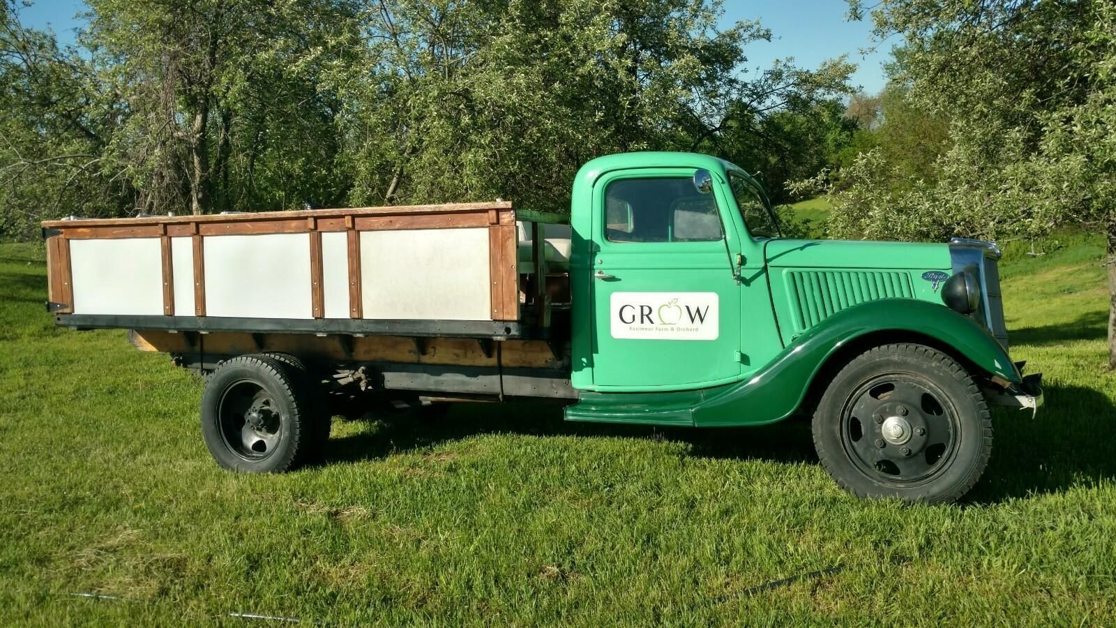 A green truck with the word grow on the side
