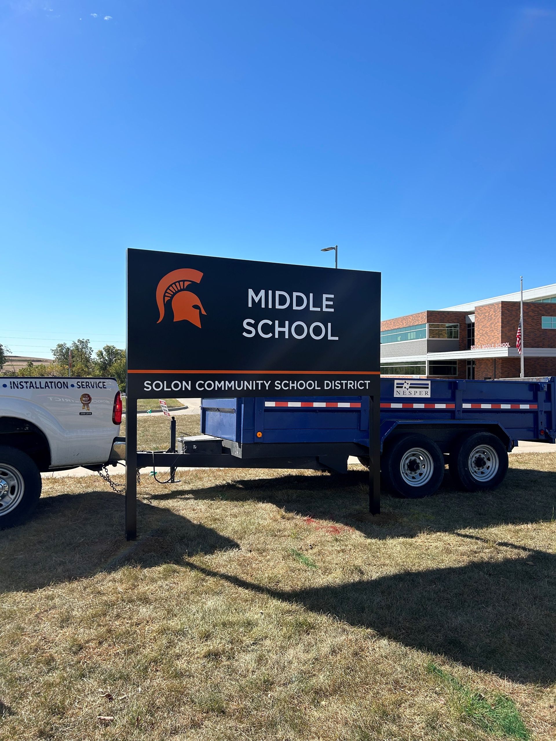 A middle school sign is attached to a trailer