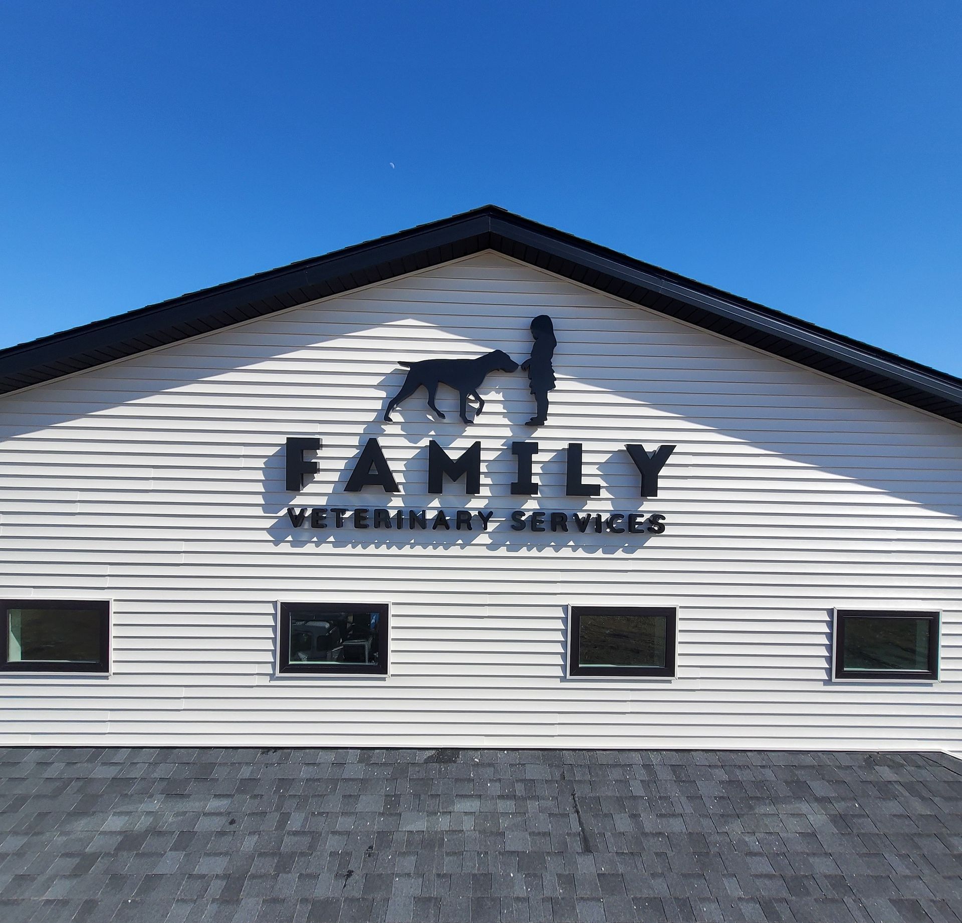A white building with a sign that says family veterinary services