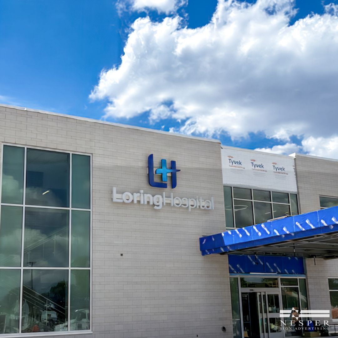 A Loring Hospital building with a blue awning.