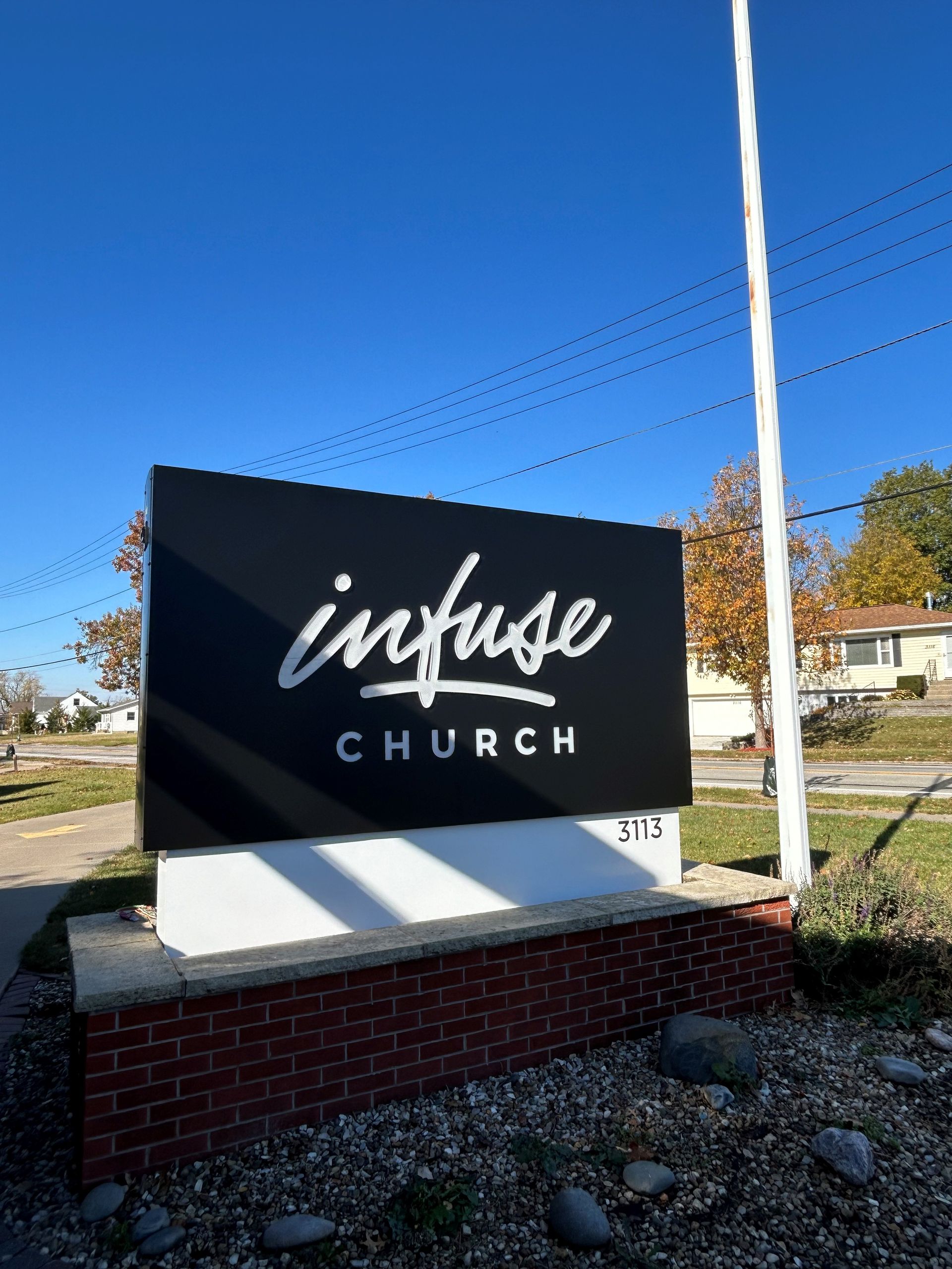 A black and white sign for infuse church