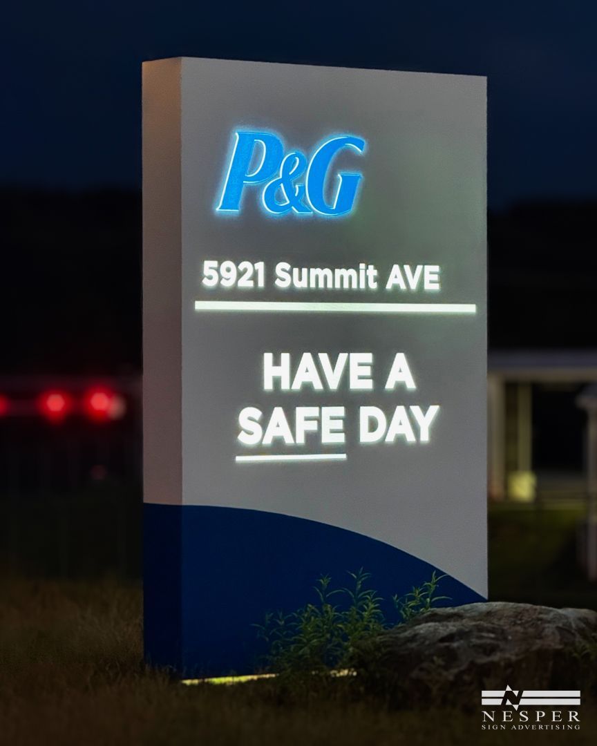 Sign for P&G at 5921 Summit Ave, lit up at dusk, says
