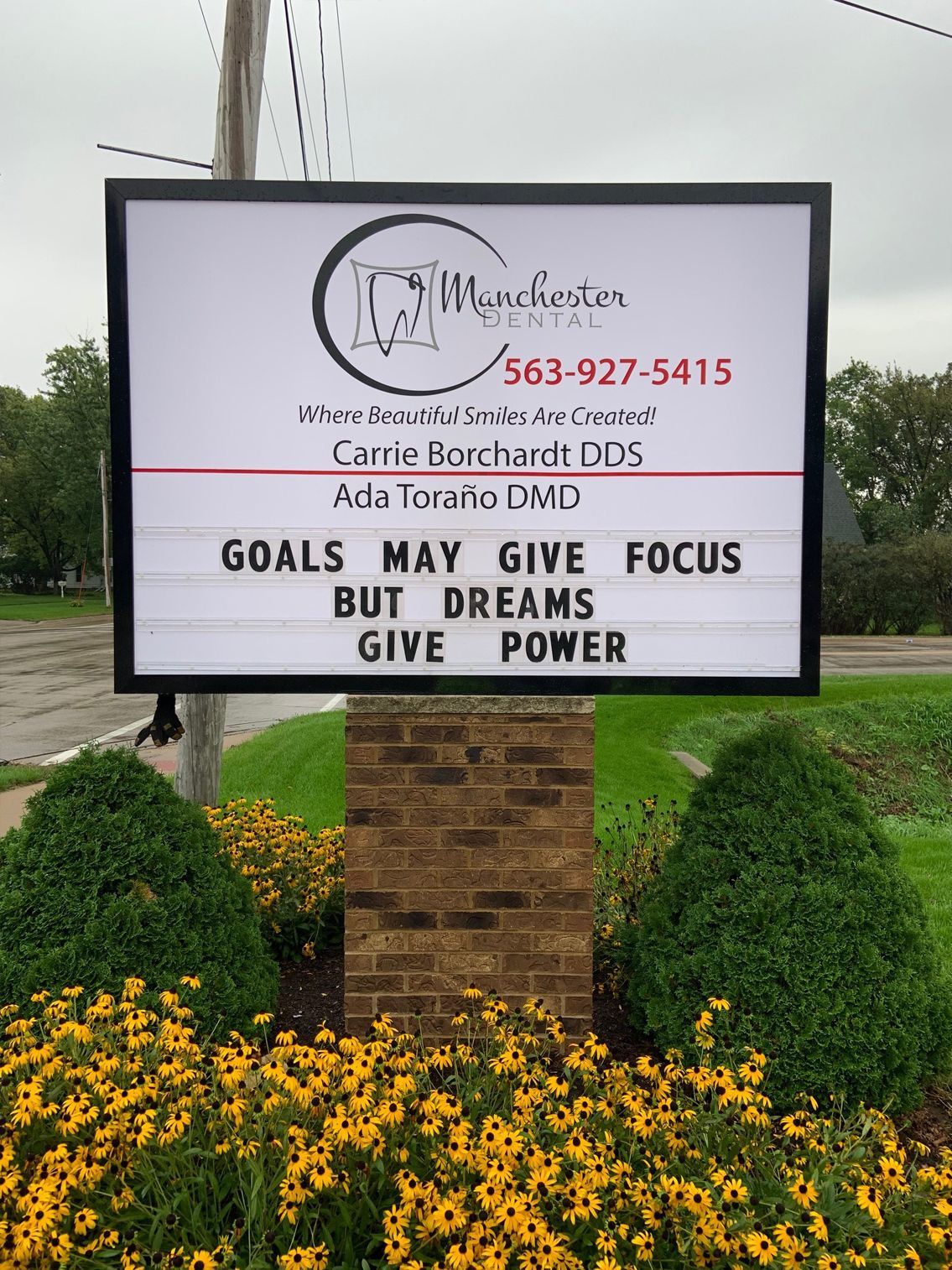 Sign for Wenchester Dental clinic. Text reads: 'Goals may give focus, but dreams give power.'