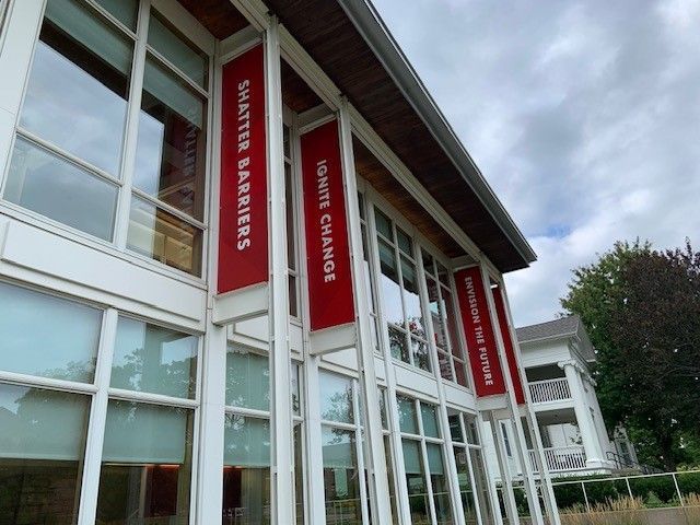 A building with a red banner that says waste barriers