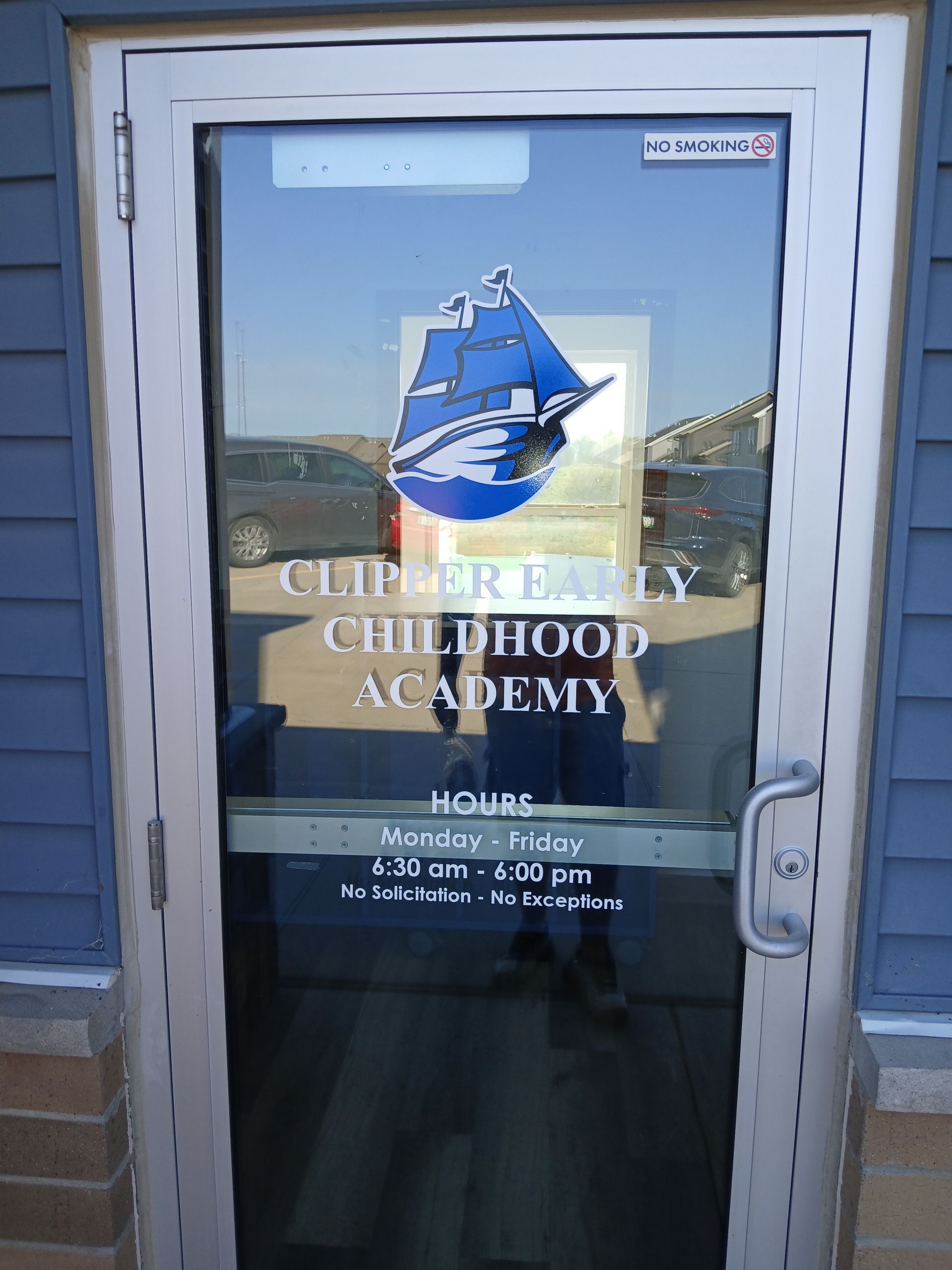 A door that says clipper family childhood academy on it