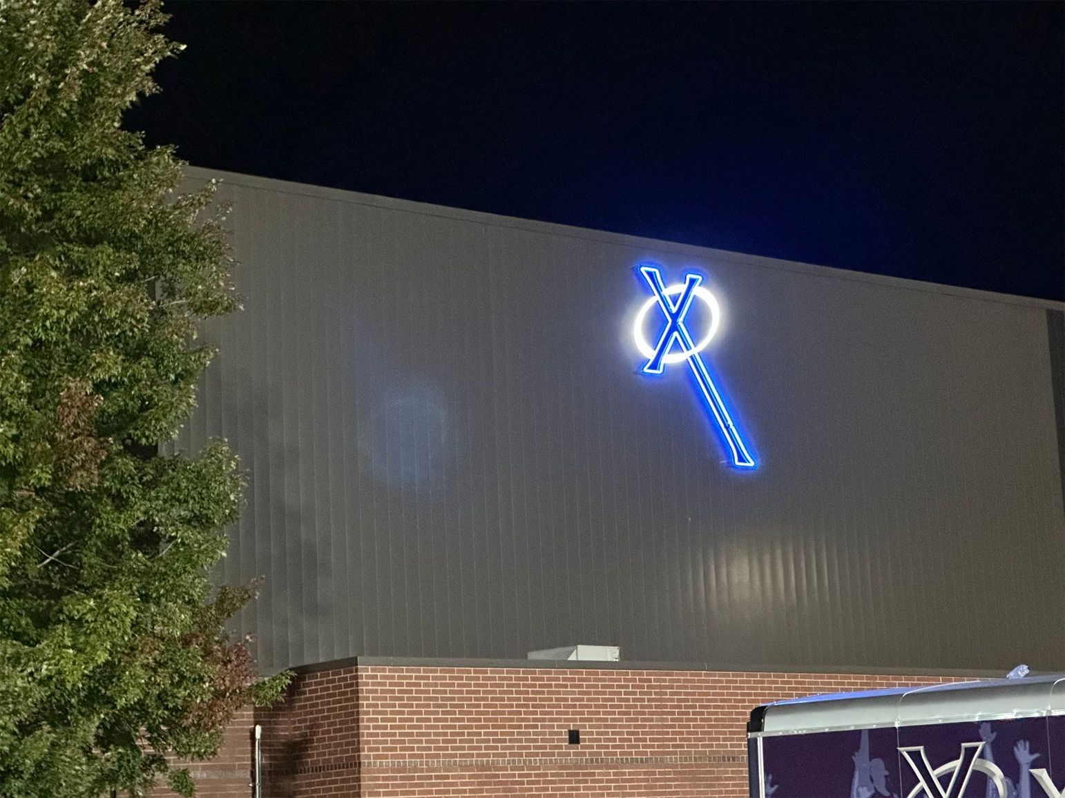 A building with a neon sign on the side of it