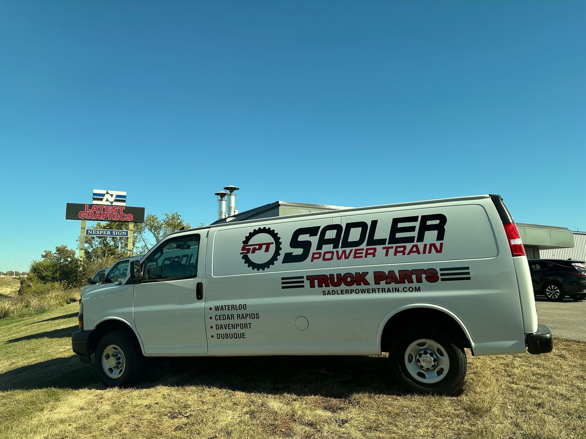 A yellow and white ambulance is parked in front of a building.