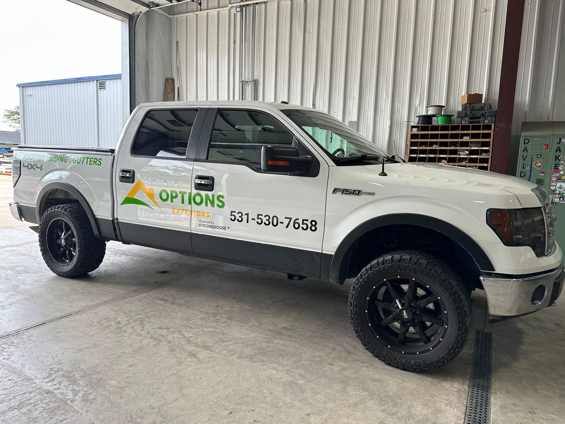 A white pickup truck with vehicle wrap
