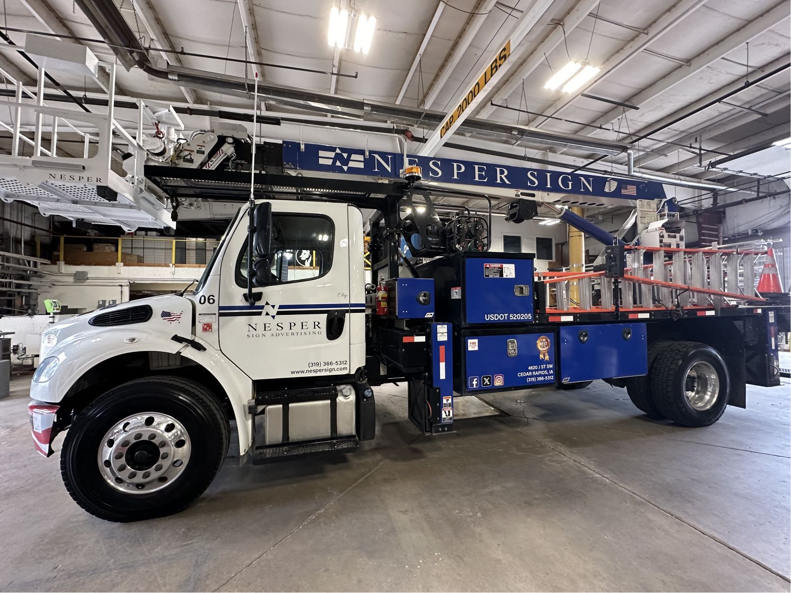 A white and blue truck with the word spectrum on the side