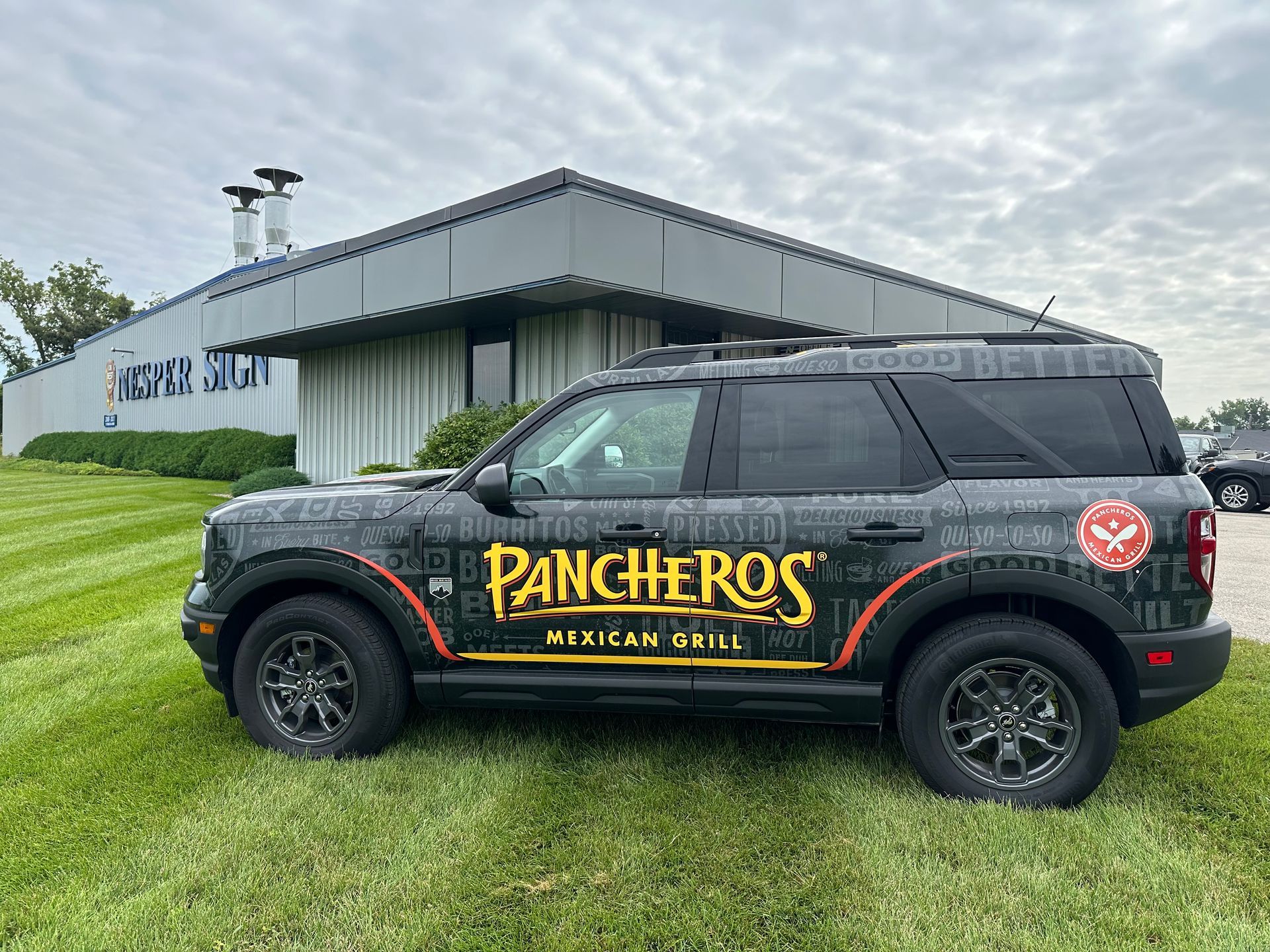 A Panchero's truck is parked in front of a building.