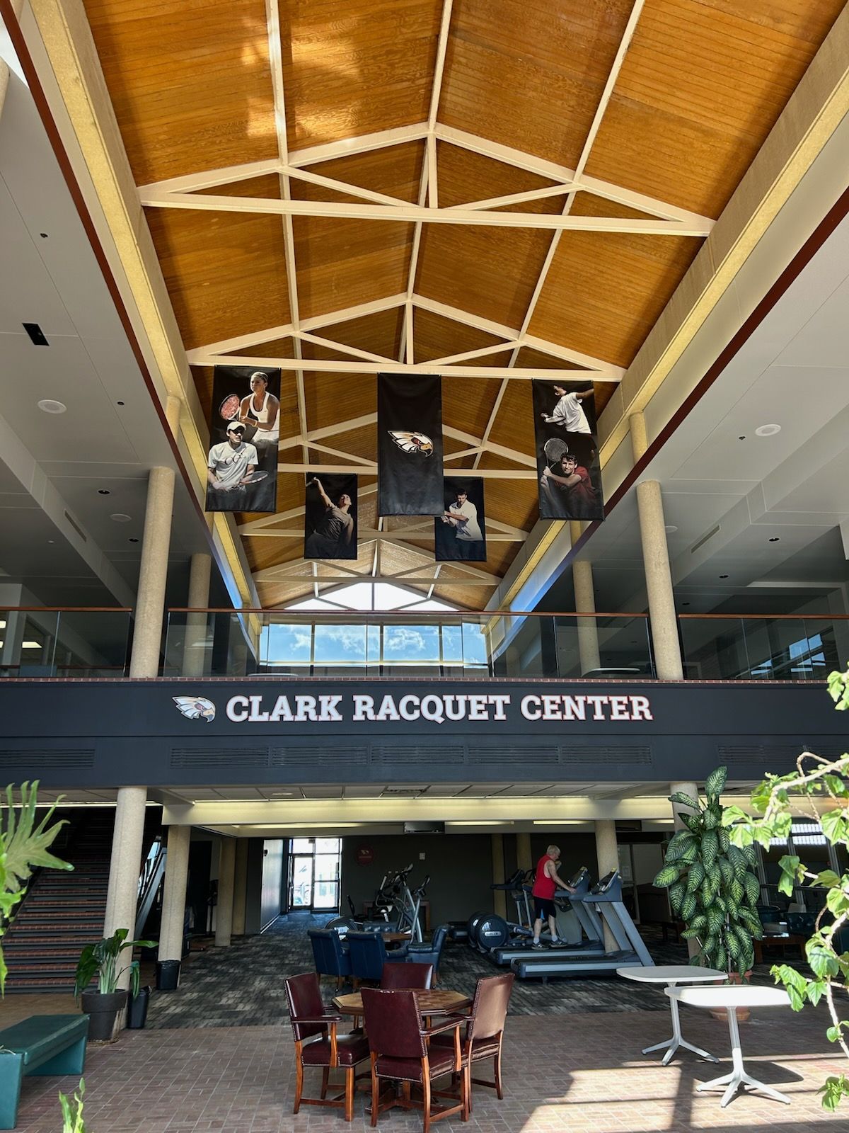 The clark racquet center is a large building with a wooden ceiling.