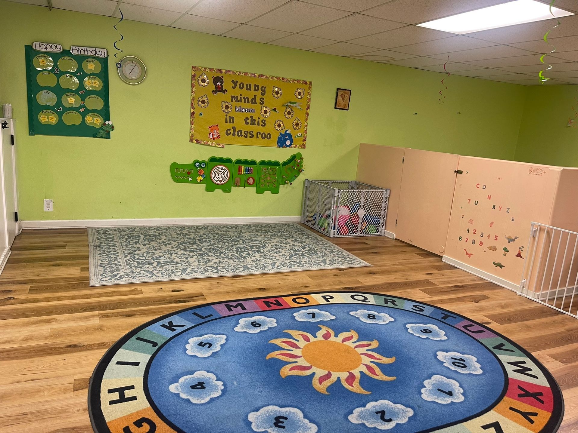 A room with a rug and a sign on the wall.