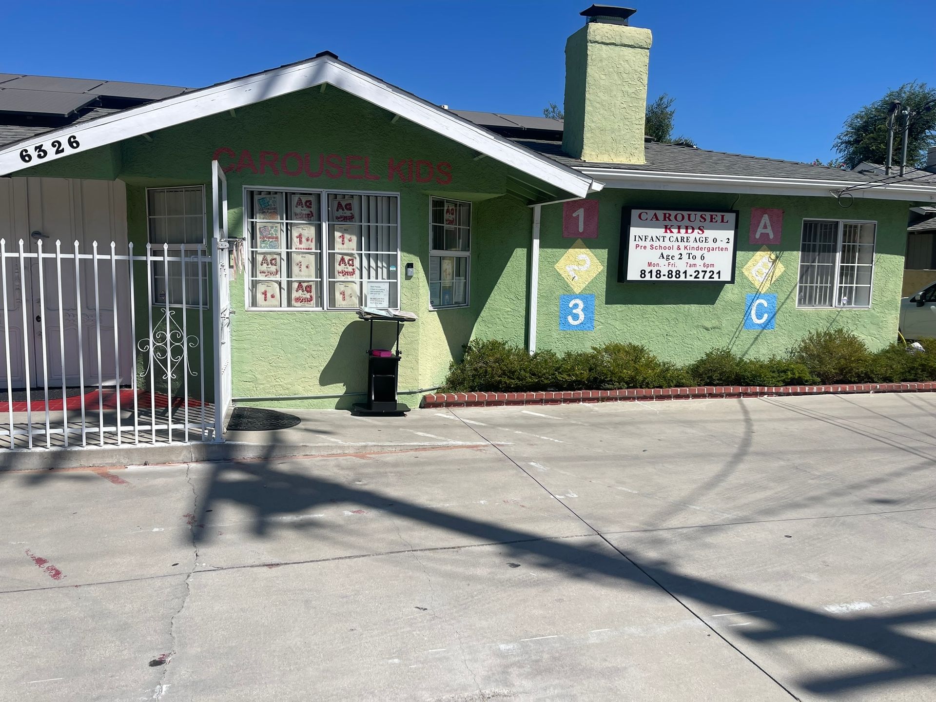 A green house with a sign that says ' a ' on it