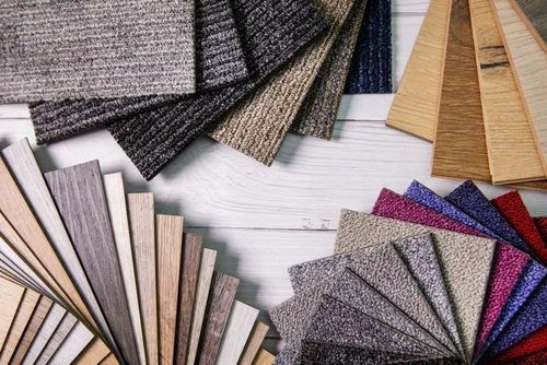 Fabric swatches in assorted colors and textures arranged in overlapping fans on a white surface