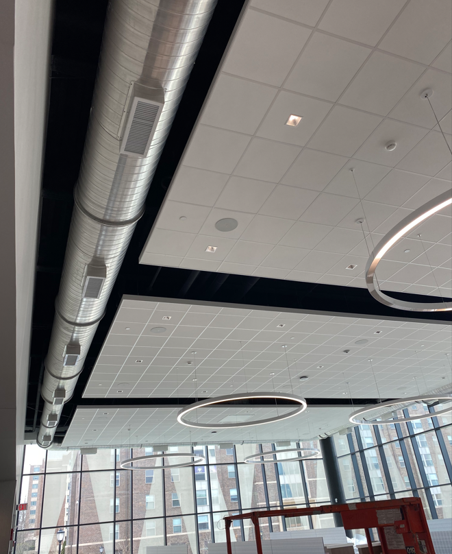 A ceiling with a lot of pipes hanging from it